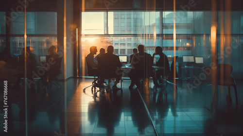 Silhouetted Business Team in a Meeting at Sunset in Modern Office