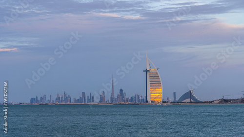Photography Dubai skyline with Burj Al Arab hotel during sunset and day to night timelapse