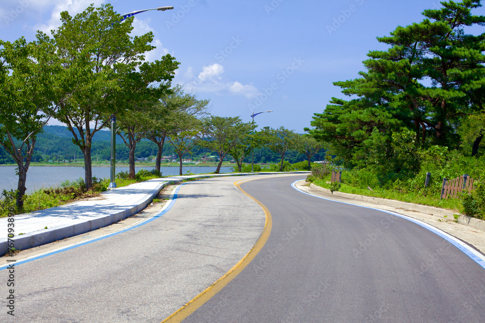 Cycling Route Along Hwajinpo Lake on a Sunny Summer Day Cycling Route Along Hwajinpo Lake on a Sunny Summer Day