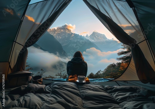 Man Sitting in Tent Gazing at Mountains