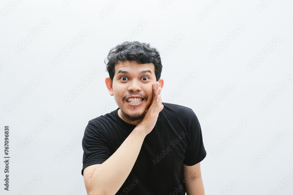 an Asian man shows a gesture of whispering something an Asian man shows a gesture of whispering something