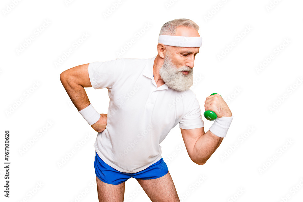 Fototapeta premium Body care, hobby, weight loss lifestyle. Cool grandpa with confident grimace exercising holding equipment up, lifts it with strength and power, wearing blue sexy shorts, show legs