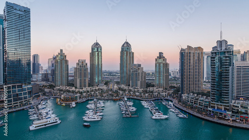 Dubai Marina skyscrapers aerial day to night timelapse, port with luxury yachts and marina promenade