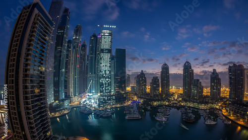 Aerial view of modern skyscrapers night to day timelapse before sunrise in Dubai Marina in Dubai  UAE.