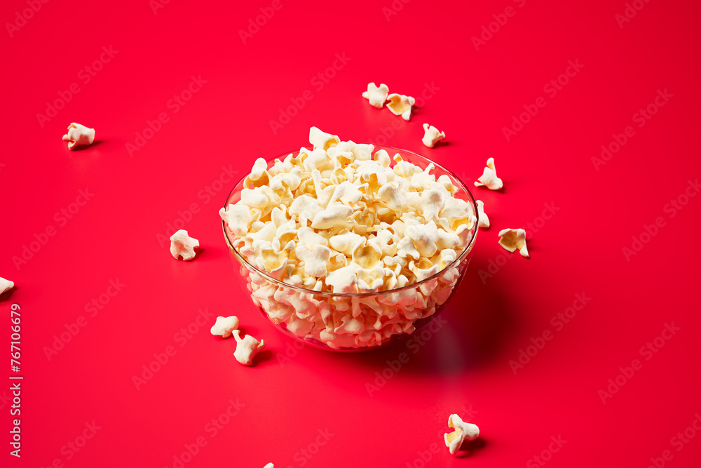 Vibrant Bowl of Fresh Popcorn Against a Bright Red Background, Perfect Snack Vibrant Bowl of Fresh Popcorn Against a Bright Red Background, Perfect Snack