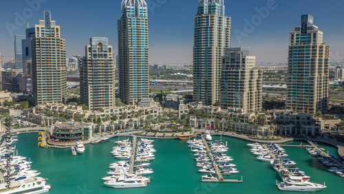 Dubai Marina skyscrapers aerial timelapse, port with luxury yachts and marina promenade