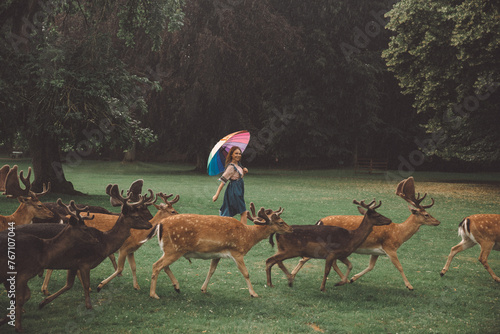 Girl Walking with Deer in Blatna Castle Park, Czech Republic photo