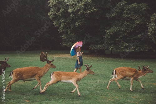 Girl Walking with Deer in Blatna Castle Park, Czech Republic photo