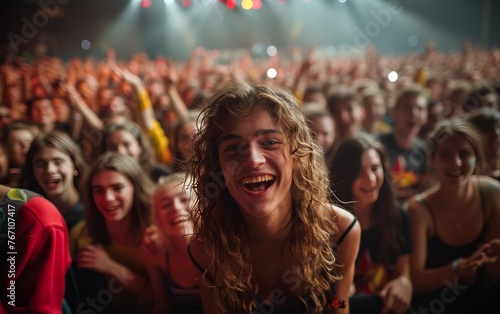 A woman with long hair is smiling and holding her hands up in the air