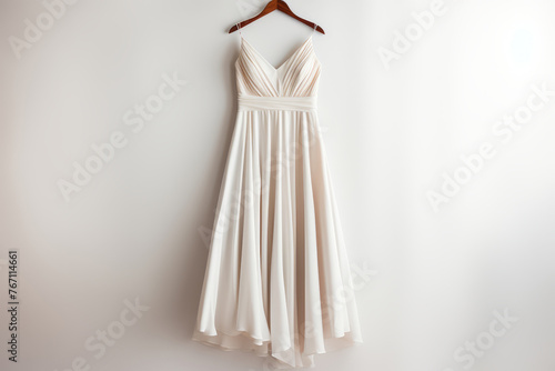 Elegant Wedding Dress Hanging on White Wall, Bridal Gown for Special Day