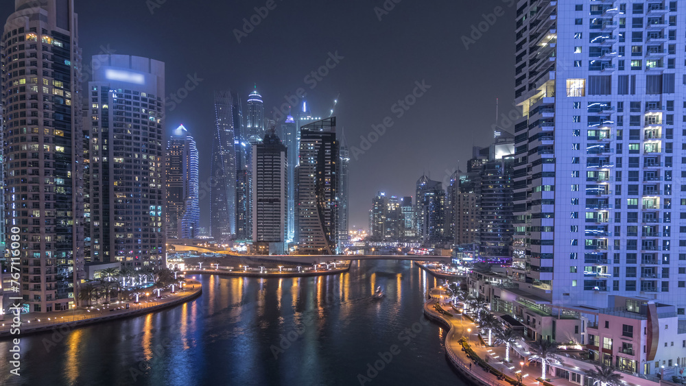 Water canal on Dubai Marina skyline at night timelapse.