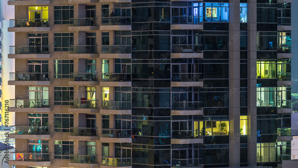 Glowing windows of skyscrapers at evening timelapse