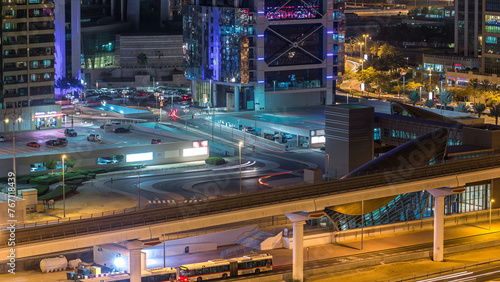 Aerial view of Jumeirah lakes towers skyscrapers night timelapse with traffic on sheikh zayed road. photo