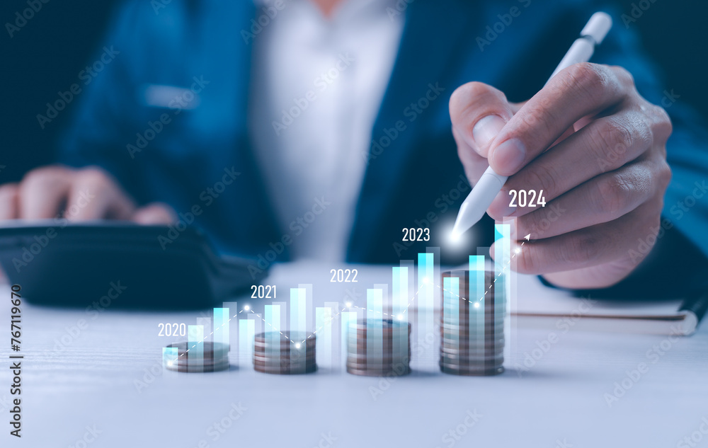 Close-up businessperson analyzing a holographic financial chart. Conceptual image for financial analysis, forecasting, and digital economy. Growth of year, 2024, businessman calculates financial data.