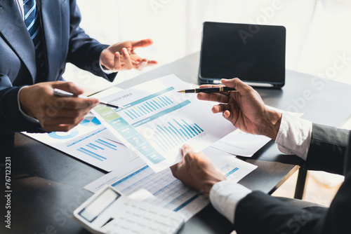 Meeting of financial advisors is discussing analyzing the financial growth chart of the business and planning investments in the growing market. Strategy analysis and business planning.