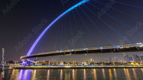 Futuristic Pedestrian Bridge over the Dubai Water Canal Illuminated at Night timelapse hyperlapse, UAE.