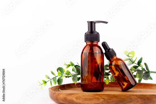 Set of natural organic SPA beauty products on wooden board isolated on white background. Amber glass spray bottle, homemade soap, serum. Bio cosmetics branding, packaging design..