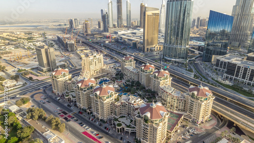 Fototapeta Naklejka Na Ścianę i Meble -  Dubai downtown skyline at sunset timelapse and road traffic near mall, UAE