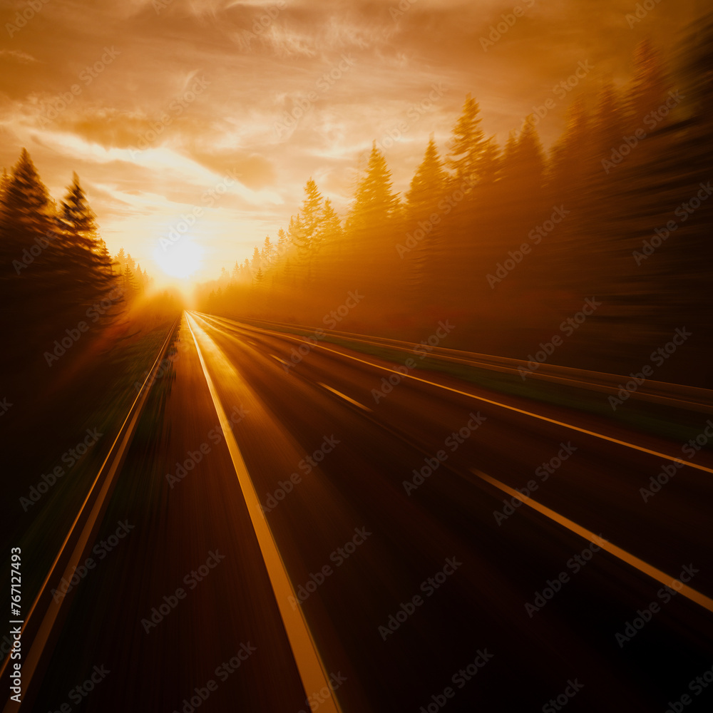 Enchanting Sunset View over a Blurry Highway Through Dense Forests