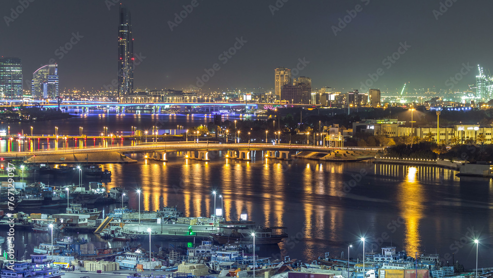 Dubai creek landscape night timelapse with boats and ship near waterfront