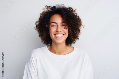 Portrait of a beautiful young african american woman smiling against grey background