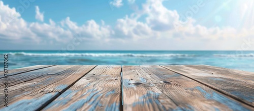 Wooden table surface with a blurred background of a summer blue sea and sky. Space available for showcasing or designing products.