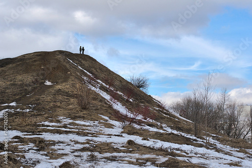 two people on top of a hill