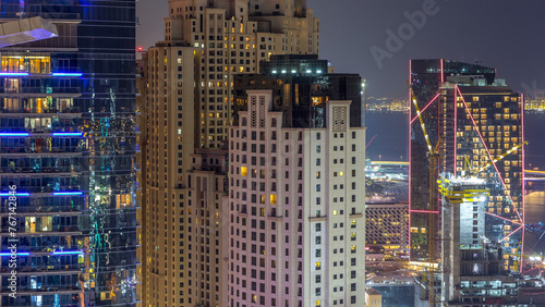 Aerial view of modern skyscrapers and beach at Jumeirah Beach Residence JBR night timelapse in Dubai  UAE