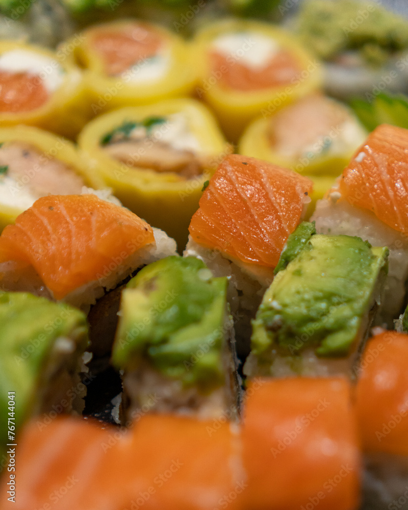 Close up macro shot of delicious gourmet Sushi in a black table with black plates Close up macro shot of delicious gourmet Sushi in a black table with black plates