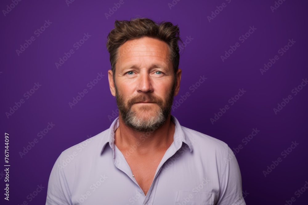Portrait of a handsome man with beard and mustache over purple background. Portrait of a handsome man with beard and mustache over purple background.