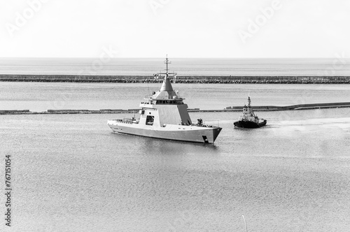 Canvastavla Coast Guard Ship entering port with the help of a tugboat, after exercises at sea