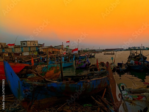 landscape golden sunset photography of fishing boats in the coastal area of Tambak Lorok, Semarang photo