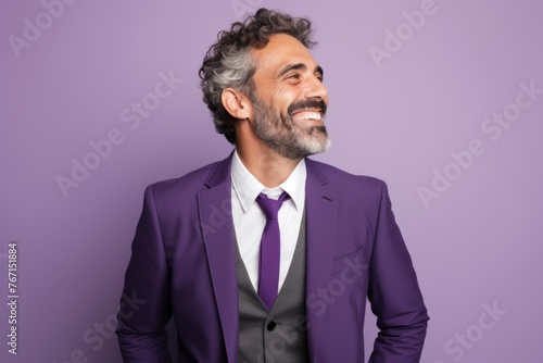 Handsome middle-aged man in a purple suit on a purple background