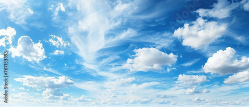 Bright blue sky with soft clouds dispersed across