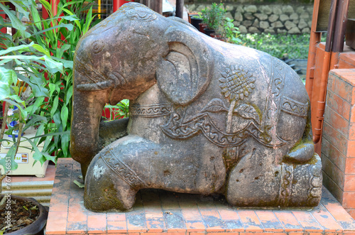 Ancient sculpture carving stone rock elephants statue lanna style in for thai traveler people travel visit in park at Wat Phra Kaew or Pa Ya or Pa Yiea temple at Chiangrai city in Chiang Rai, Thailand