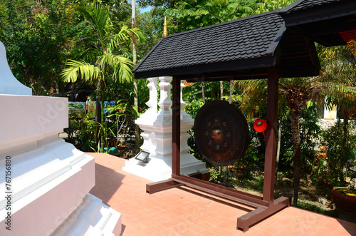Antique stone bell for thai traveler people travel visit and knock gong respect blessing pray to Emerald Buddha or Phra Kaeo Morakot at Wat Phra Kaew or Pa Ya or Pa Yiea temple in Chiang Rai, Thailand photo