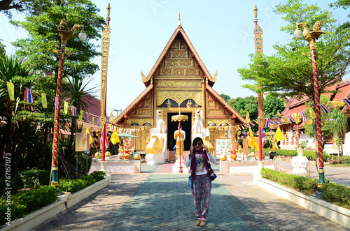 Thai travelers women people travel visit respect praying blessing wish myth holy mystical worship and ancient Phra Sing buddha statue of Wat Phra Singh temple at Chiangrai city in Chiang Rai, Thailand