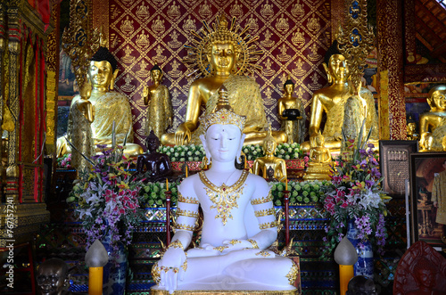 Ancient buddha in antique ubosot of Wat Phra Singh or Phra Sing temple for thai people traveler visit respect praying blessing wish myth holy mystical worship at Chiangrai city in Chiang Rai, Thailand