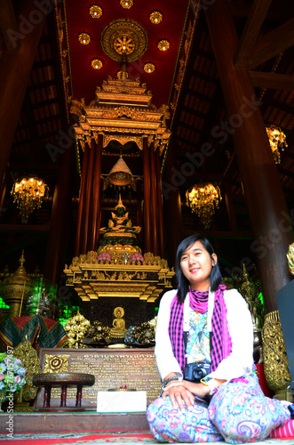 Travelers thai women people travel visit and respect praying blessing wish holy mystery Emerald Buddha statue or Phra Kaeo Morakot of Wat Phra Kaew temple on February 24, 2015 in Chiang Rai, Thailand