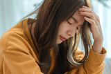 Closeup - Depressed young woman sitting on couch in the living room at home, Frustrated confused female feels unhappy problem in personal life quarrel break up with boyfriend