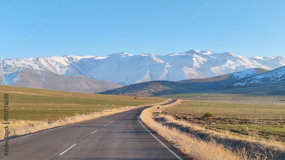 Fototapeta premium Inspiring journey through the serene steppes with distant snow-capped mountains in Central Turkey in January