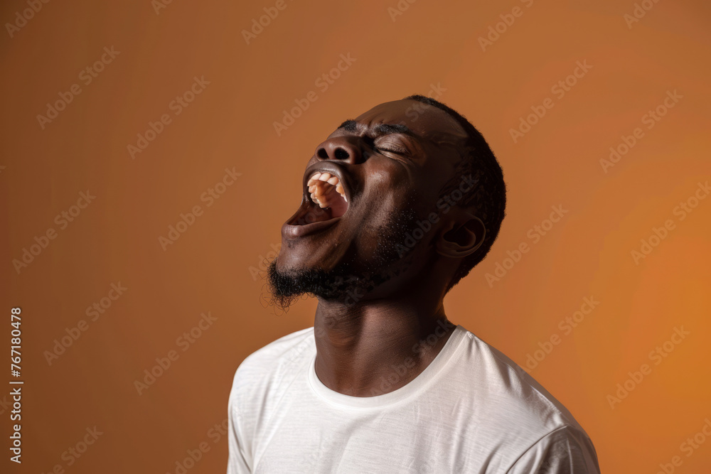 Portrait of a shouting african american young man wearing white shirt isolated on empty meringue background with space for text or inscriptions.
Portrait of a shouting african american young man wearing white shirt isolated on empty meringue background with space for text or inscriptions.