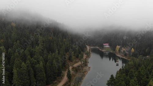 View of small Akgol lake in Ayancik, Sinop around big mountains with high pine trees on cloudy sky background. photo