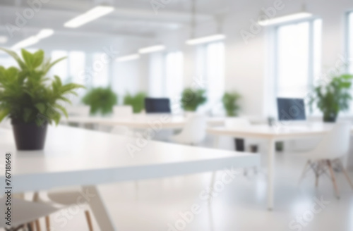 Blurred empty modern office. Defocused abstract light bokeh business eco open space interior background design. Corporate strategy  finance  operations  marketing. Tables with computers blur focus