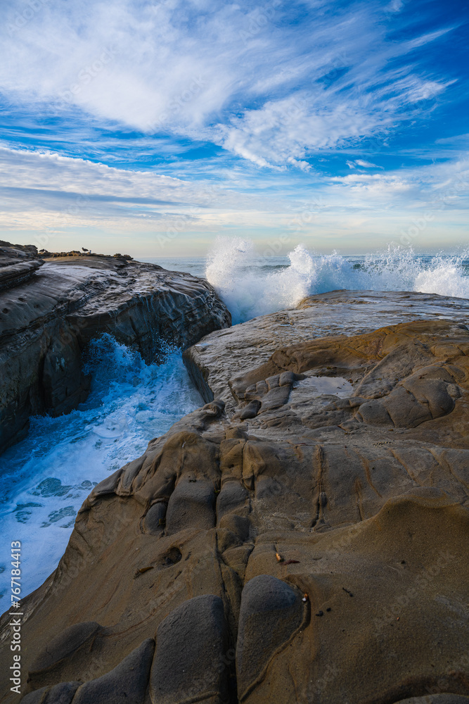 2022-01-14 WAVES CASHING ON THE ROCKS ALONG THE LA JOLLA SHORELINE WITH WATER SPRAYING AND A NICE BLUE SKY WITH NICE CLOUDS NEAR SAN DIEGO 2022-01-14 WAVES CASHING ON THE ROCKS ALONG THE LA JOLLA SHORELINE WITH WATER SPRAYING AND A NICE BLUE SKY WITH NICE CLOUDS NEAR SAN DIEGO