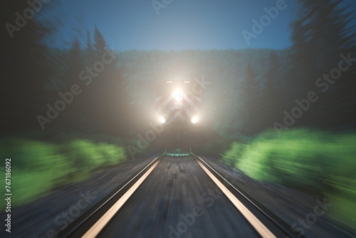 Twilight Spectacle: Speeding Train Illuminates Tracks Amidst Verdant Foliage