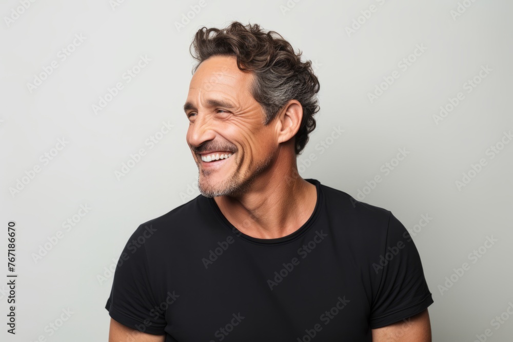 Portrait of a handsome middle-aged man laughing over gray background Portrait of a handsome middle-aged man laughing over gray background