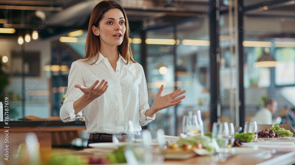 A woman is standing in front of a table with a variety of food items ...