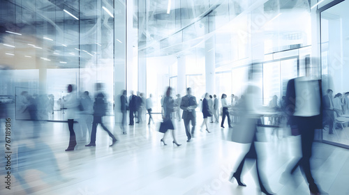 Blurred business people walking in an office during rush hour