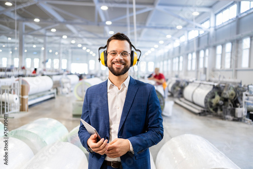 фотографія Portrait of successful caucasian manager in business suit standing in factory production hall